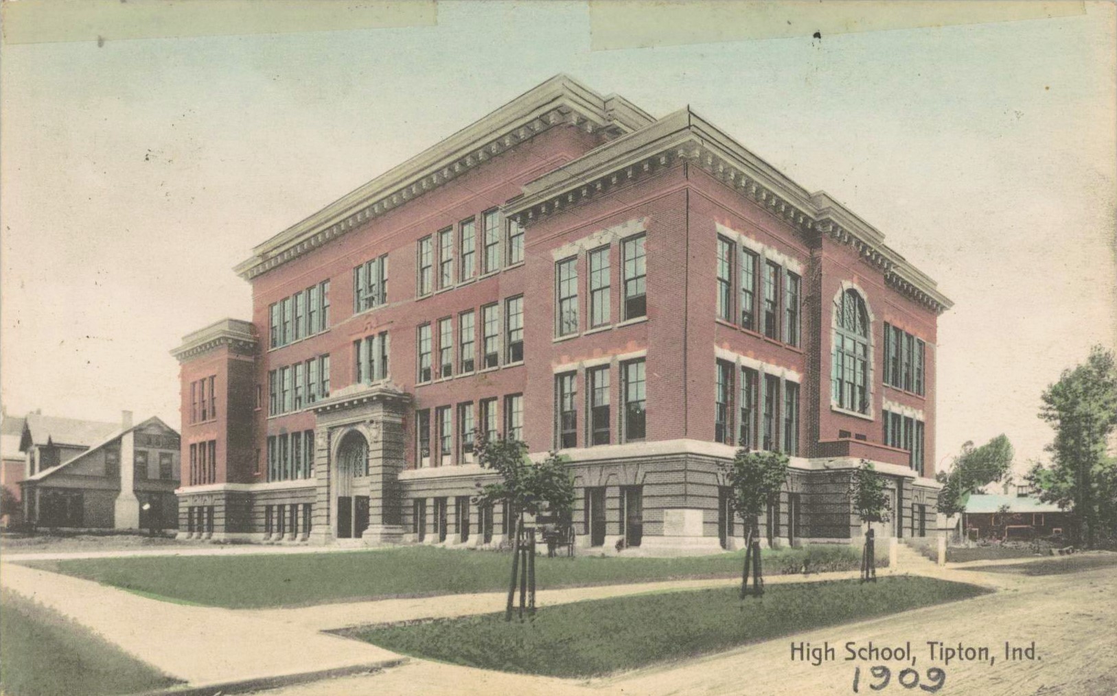 Tipton High School in 1909. A few new trees stand in front of the building, which looks to be four stories tall.