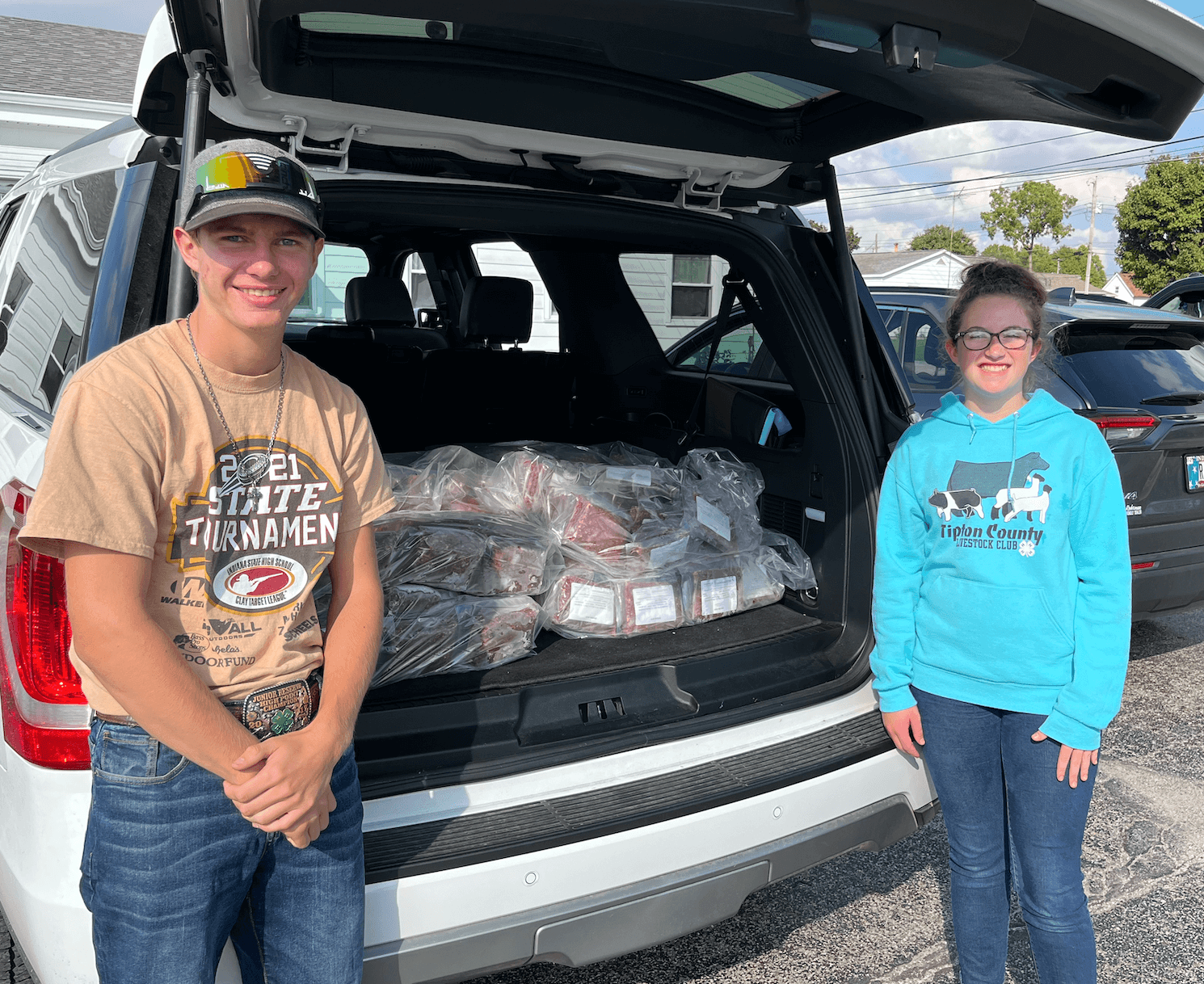 Darci Dunn and Eric Grimes stand in front of a van packed with beef for donation