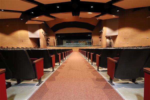 View of the auditorium from the back from the angle of an aisleway.