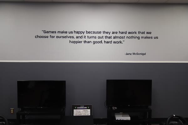 Closeup view of a quote on the wall about gaming. It's by Jane McGonigal.