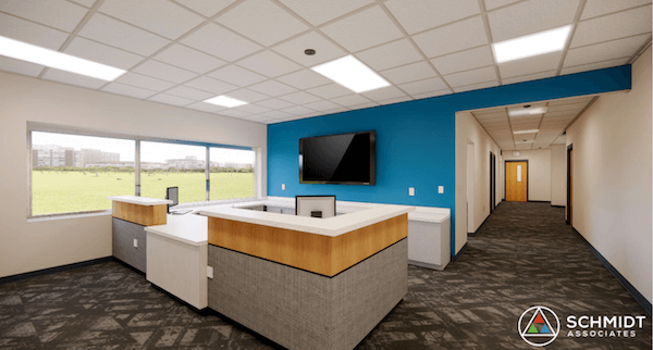 A nice blue wall, large windows, and a cozy reception desk make the office look neat and modern.