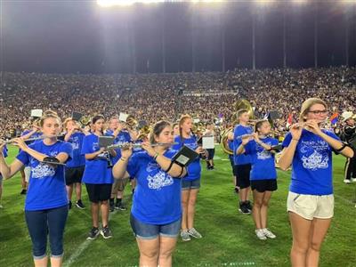 TCSC students sporting blue shirts perform on-field.